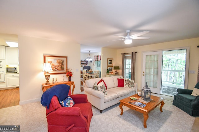 living room with ceiling fan and light hardwood / wood-style floors