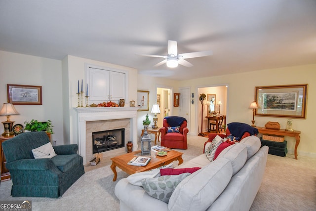 carpeted living room featuring ceiling fan and a high end fireplace