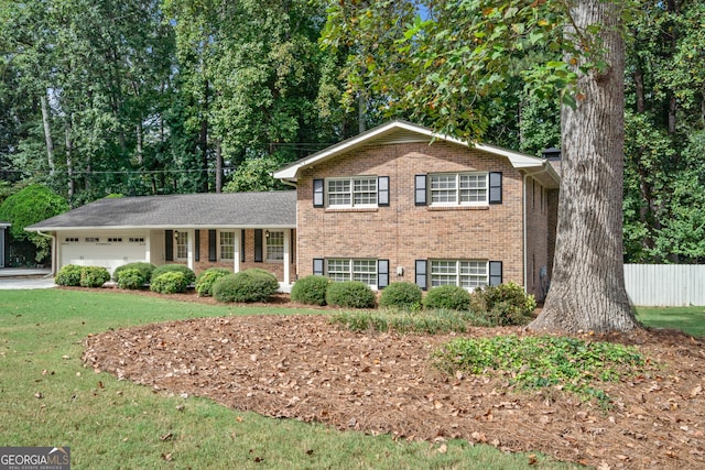 split level home featuring a garage and a front yard