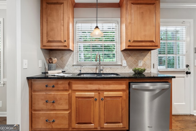 kitchen with a healthy amount of sunlight, stainless steel dishwasher, sink, and decorative backsplash