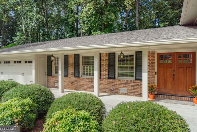 single story home with a garage and a porch