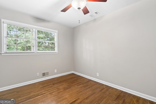 spare room with hardwood / wood-style floors and ceiling fan