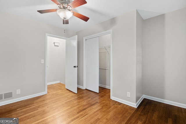 unfurnished bedroom featuring a closet, ceiling fan, and hardwood / wood-style flooring