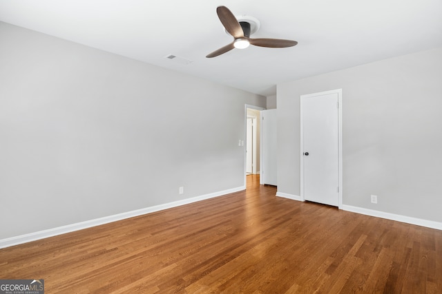 empty room featuring ceiling fan and wood-type flooring