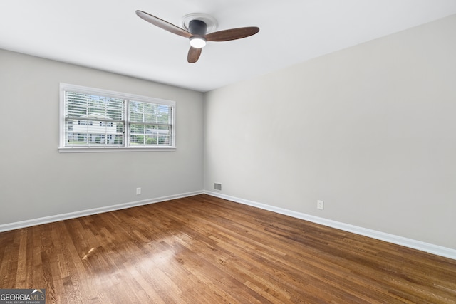 unfurnished room with ceiling fan and hardwood / wood-style floors