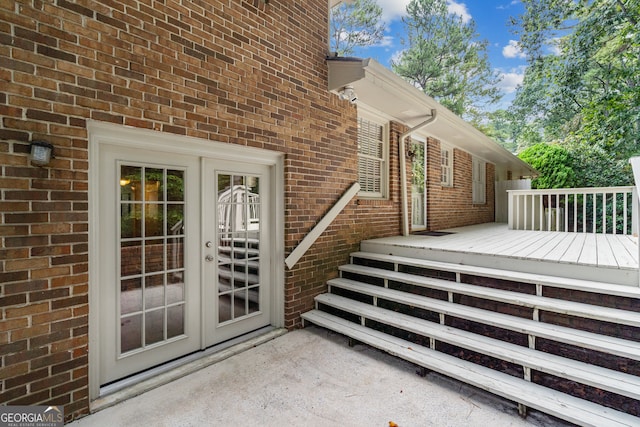 doorway to property with a wooden deck and french doors