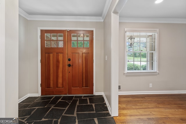 foyer entrance with crown molding and dark hardwood / wood-style floors