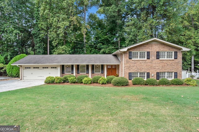 split level home with a garage and a front yard