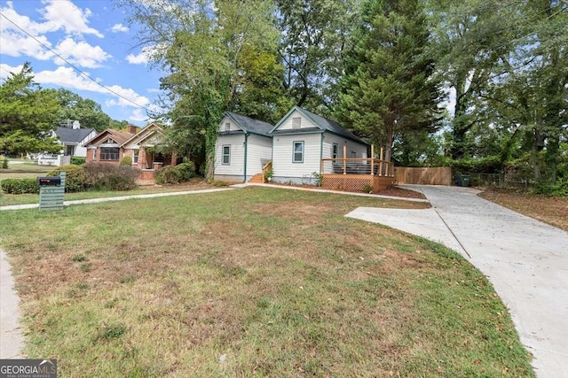 view of front of property with a front lawn and a wooden deck