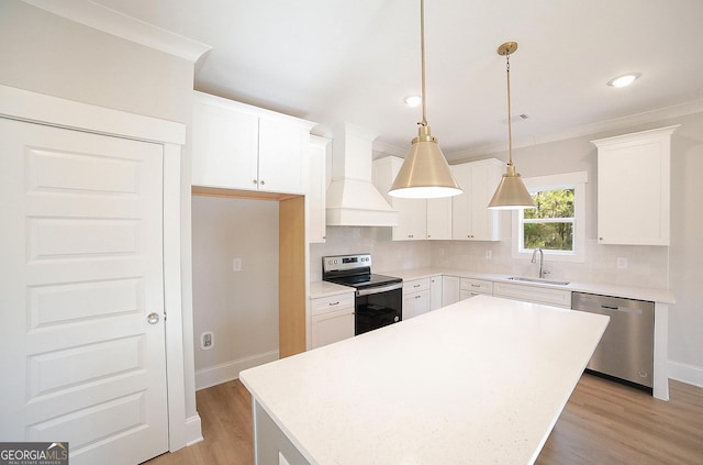 kitchen featuring white cabinetry, a kitchen island, custom range hood, and appliances with stainless steel finishes