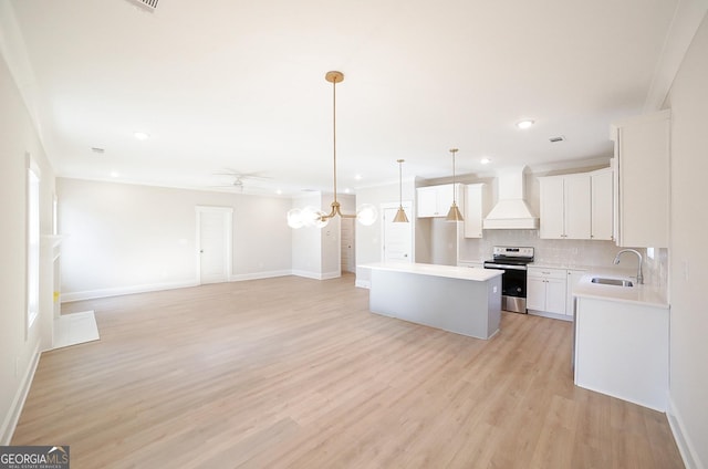 kitchen featuring custom exhaust hood, sink, a center island, white cabinetry, and stainless steel range with electric cooktop