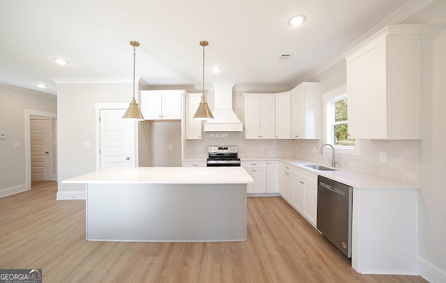 kitchen with custom exhaust hood, a center island, sink, appliances with stainless steel finishes, and white cabinetry