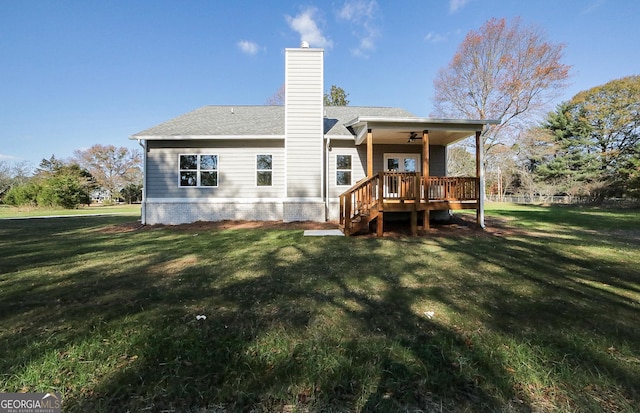 back of house featuring a lawn and ceiling fan