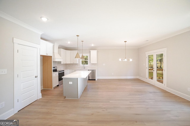 kitchen with appliances with stainless steel finishes, a center island, light hardwood / wood-style flooring, and white cabinetry