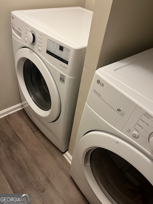 washroom with separate washer and dryer and dark hardwood / wood-style floors