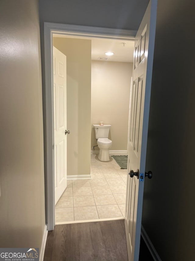 bathroom with toilet and hardwood / wood-style floors