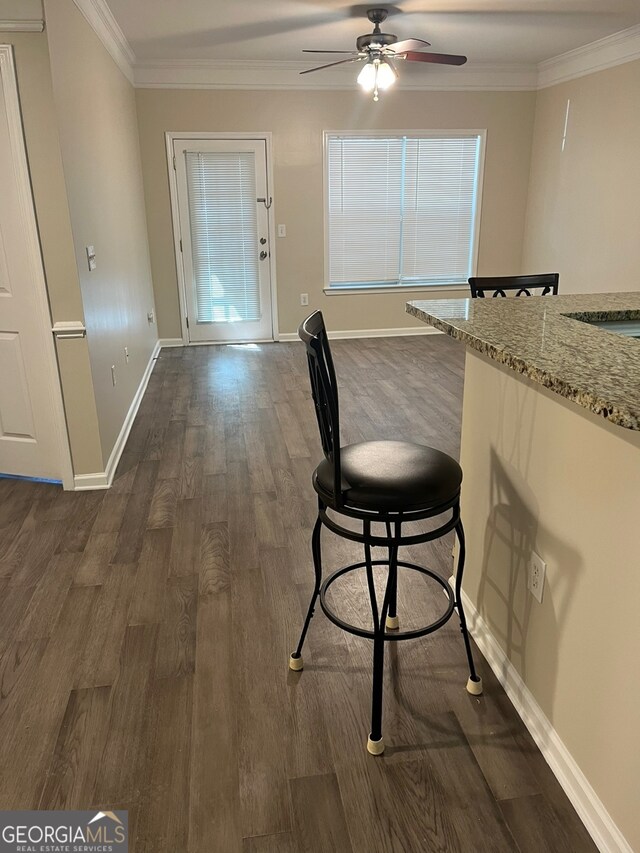 dining space featuring ornamental molding, dark hardwood / wood-style flooring, and ceiling fan