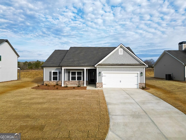 craftsman-style home with central AC, a garage, and a front lawn