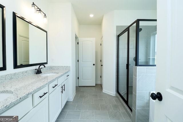 bathroom featuring tile patterned flooring, vanity, and walk in shower