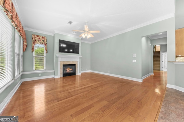 unfurnished living room featuring light wood-type flooring, ceiling fan, and crown molding