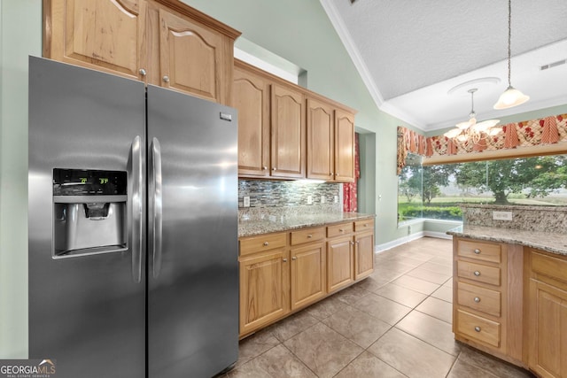 kitchen with a notable chandelier, stainless steel refrigerator with ice dispenser, lofted ceiling, and ornamental molding