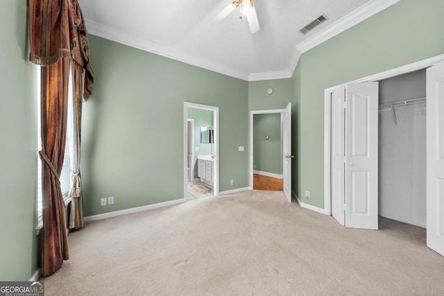 unfurnished bedroom with light carpet, a closet, ceiling fan, and crown molding