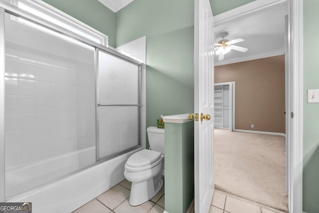 bathroom with ceiling fan, toilet, enclosed tub / shower combo, and tile patterned floors