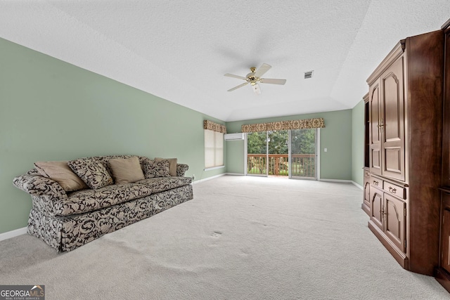 carpeted living room featuring ceiling fan and a textured ceiling