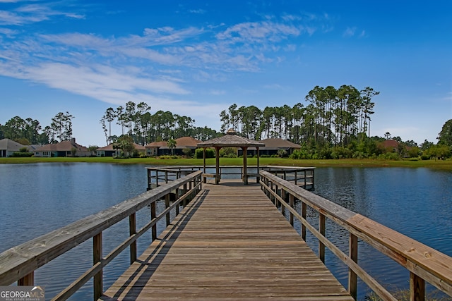 view of dock featuring a gazebo and a water view