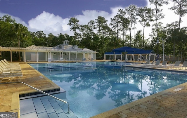 pool at dusk featuring a patio