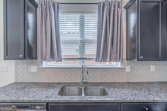 kitchen with tasteful backsplash, sink, and light stone countertops