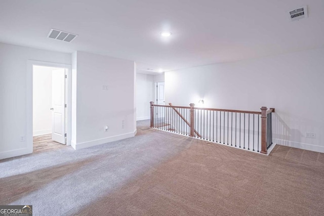 unfurnished room with light colored carpet