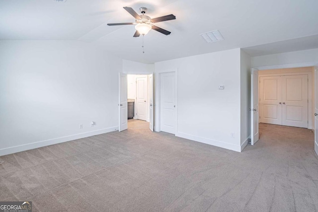 unfurnished bedroom with lofted ceiling, ceiling fan, and light colored carpet