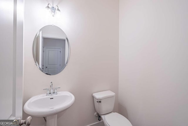 bathroom with toilet and sink