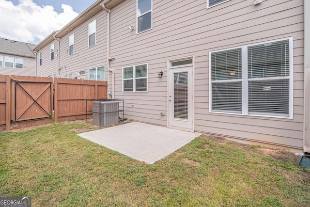 back of property featuring a lawn, a patio area, and central AC unit