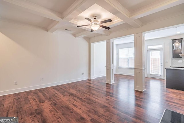 unfurnished living room with ceiling fan, dark hardwood / wood-style floors, decorative columns, and beam ceiling