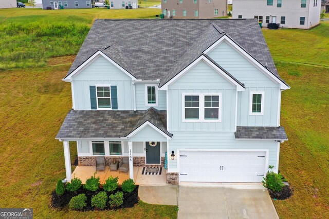 view of front facade with a yard and a garage