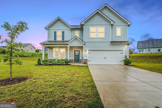 craftsman inspired home with a lawn and a garage