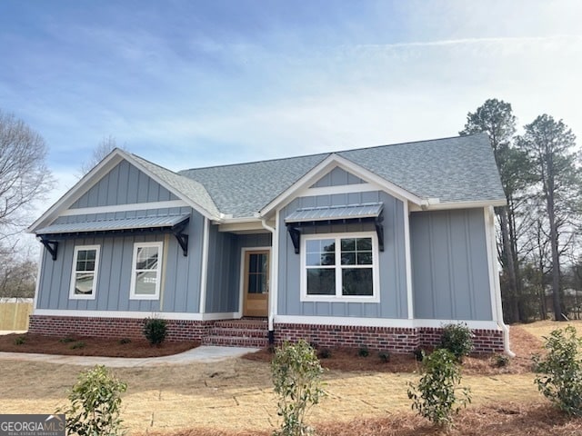 view of front facade featuring board and batten siding and a shingled roof