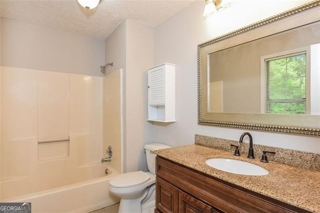 full bathroom with vanity, toilet, a textured ceiling, and  shower combination