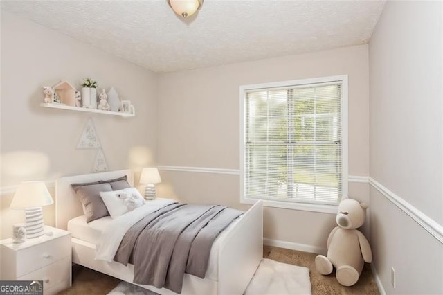 carpeted bedroom featuring a textured ceiling