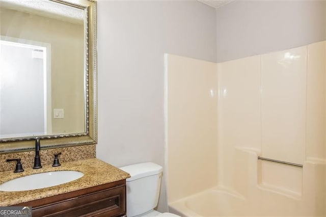 bathroom featuring toilet and vanity