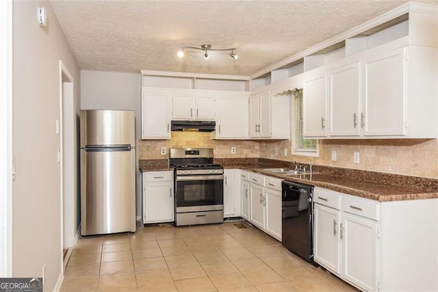 kitchen featuring a textured ceiling, stainless steel appliances, light tile patterned floors, and white cabinetry