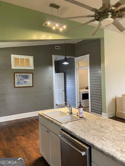 kitchen featuring sink, ceiling fan, hanging light fixtures, dark wood-type flooring, and stainless steel dishwasher