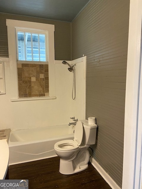 full bathroom with washtub / shower combination, toilet, hardwood / wood-style flooring, and vanity