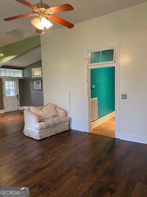 unfurnished living room with vaulted ceiling, wood-type flooring, and ceiling fan