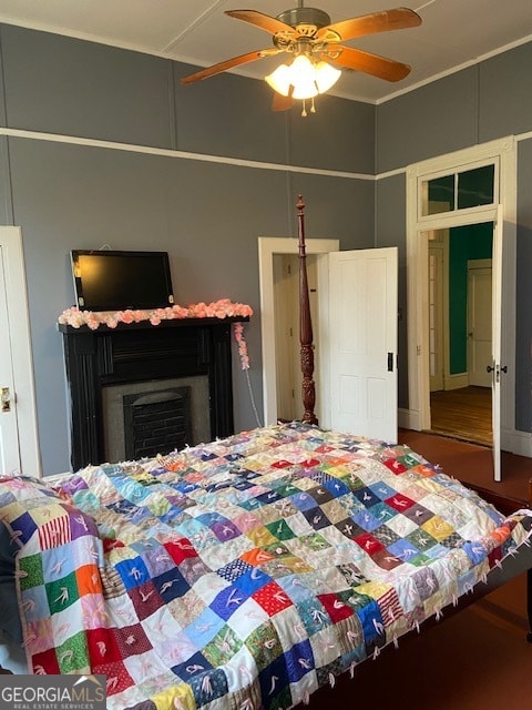 bedroom with ceiling fan and hardwood / wood-style floors