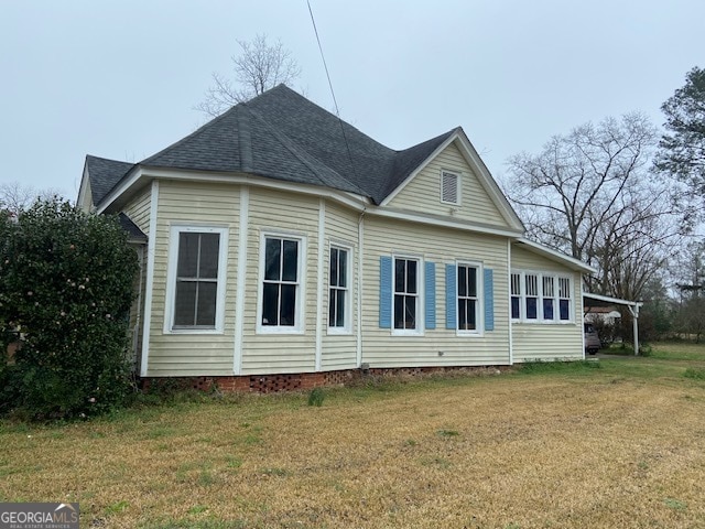 view of side of home featuring a lawn