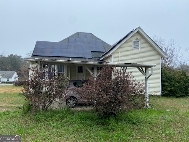 exterior space featuring a lawn and solar panels