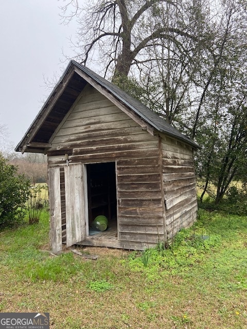 view of outbuilding featuring a lawn